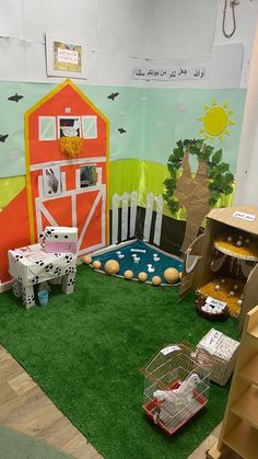 an indoor play area with fake grass and toys