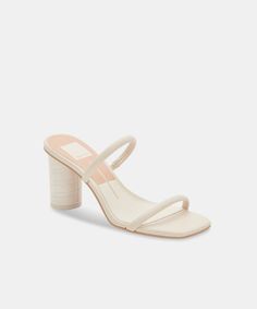 Do a double-take. We're living for NOLES' two-strap silhouette, finished with a chunky round heel. Synthetic Upper Rubber Outsole Synthetic Lining Heel Height: 3.35 Imported Round Heels, Ivory Heels, Cream Heels, Pretty Sandals, Neutral Heels, Fashion Shoes Heels, Wide Heels, Trending Sandals, Shoe Inspo