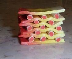 a stack of yellow and red toothbrushes sitting on top of a countertop