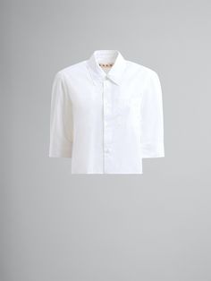 Cotton poplin shirt. Cocoon fit with cap sleeves and gathering on the back yoke. Button closure. Short Sleeve Poplin Blouse For Work, Short Sleeve Poplin Tops For Work, Poplin Short Sleeve Workwear Blouse, Fitted Poplin Top For Office, Classic Short Sleeve Poplin Shirt, Daywear Tops With Button Closure, Poplin Tops With Cuffed Sleeves For Workwear, Poplin Tops With Button Closure For Daywear, Fitted Poplin Office Top