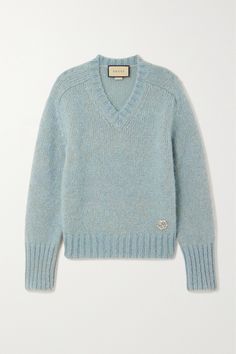 Gucci's chunky sweater is subtly embellished with shimmering crystals in the shape of the interlocking 'G' emblem but remains minimally detailed otherwise. Spun from soft mohair-blend, this style has a deep V-neckline and thickly ribbed trims at the cuffs and hem. The light-blue shade will pair well with neutrals. Gucci Clothes Women, Gucci Outfits Women, Woburn Abbey, Shop Gucci, Chanel Sweater, Gucci Clothes, Stylish Knitwear, Fashion Knitting, Gucci Sweater