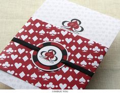 an open red and white card with hearts on it, sitting on top of a table