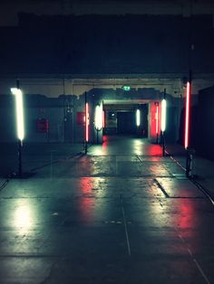 an empty parking garage with red and white lights