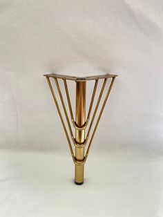 a gold metal table with a white background