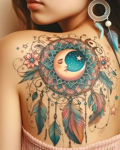 the back of a woman's shoulder with a dream catcher and crescent moon tattoo on it