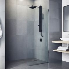 a bathroom with a glass shower door and shelves on the wall next to the sink