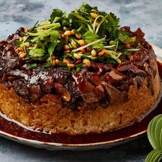 a large cake with various toppings on top of it, sitting on a plate