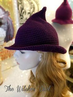 there is a mannequin head wearing a purple knitted clochet hat