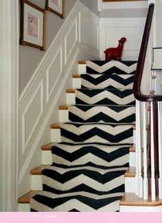 black and white chevron rugs are on the stairs