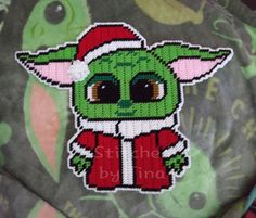 a close up of a patch on a shirt with an image of a baby yoda