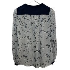 Diane Von Furstenberg Silk Blouse Navy Blue and white Floral Henley. Henley top with button details at the cuffs and balloon sleeves. Stitching details on the shoulders. Navy blue and white stripes with a floral print. Women's size 2. 100% silk. Item has a couple small pulls on the silk and a small pull on the stitches on the shoulder, as shown in photos. Measurements with the garment laying flat: Pit to pit: about 19.5 inches Length: about 24.5 inches Spring Striped Long Sleeve Blouse, Spring Long Sleeve Blouse With Striped Sleeves, Spring Blouse With Striped Long Sleeves, Long Sleeve Blouse With Striped Sleeves For Work, Spring Workwear Blouse With Striped Sleeves, Chic Long Sleeve Blouse With Striped Sleeves, Stitching Details, Blue And White Floral, Henley Top