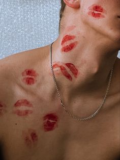 a shirtless man with red lipstick on his chest