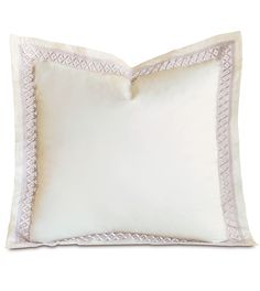 a white pillow with an embroidered border on the front and back of it's sides