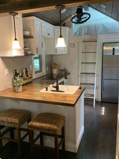 a kitchen with two stools and a sink