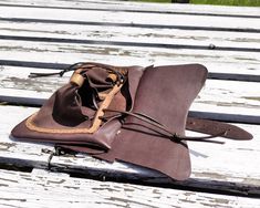 We proudly present this typical medieval men's belt bag, hanging on two loops. It's made mainly of calfskin, but pouches are made of soft goat suede. Purses like this were used in every social group, but a wealthy man could afford a decorated or more sophisticated bag. This purse is rather simple, it has a single compartment and a flap. This version has a fastening strap with a buckle made of brass. This buckle was found in Dordrecht in The Netherlands. It's dated 1350-1600. At the front, The ba Medieval Leather Pouch For Larp, Medieval Bag, Forearm Guard, Mounted Archery, Wealthy Man, Leather Belt Pouch, Wealthy Men, Leather Belt Bag, Belt Pouch