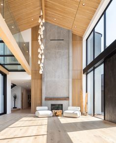 a large living room with high ceilings and floor to ceiling windows