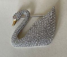 "Swarovski swan mark  clear crystal  Swan brooch  Gold and rhodium plated, clear crystal  size - 1 3/4\" x 1 1/2\"  marked: Swan mark, copyright symbol  Excellent condition ( Not new, used )  01/09/23" Luxury Silver Rhinestone Brooches, Luxury Silver Brooches With Rhinestones, White Crystal Brooch For Formal Occasions, Formal White Crystal Brooches, Luxury Rhinestone Brooch For Formal Occasions, Luxury Rhinestone Brooches For Formal Occasions, Sparkling Silver Brooches For Evening, Silver Sparkling Brooches For Evening, Elegant Sparkling Brooch For Formal Occasions