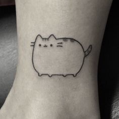 a black and white cat tattoo on the ankle, with an outline of a cat