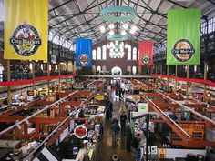 an indoor market with lots of tables and banners