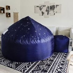 a large blue bean bag sitting on top of a black and white rug