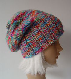 a mannequin head wearing a multicolored knitted hat with white fur