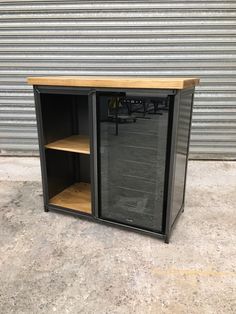 a metal cabinet with wooden shelves in front of a garage door