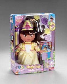 the doll is in its box and it has hair accessories on it's head