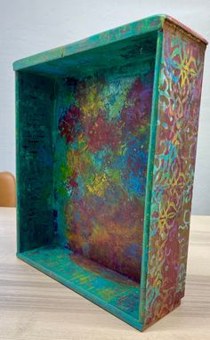 a colorful box sitting on top of a wooden table