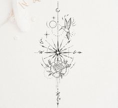 a drawing of a rose and compass on a white paper