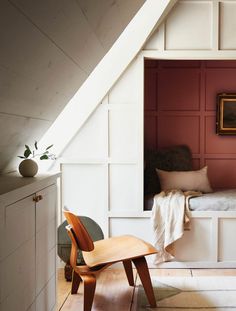 an instagramted photo of a bedroom with white walls and red paneled doors