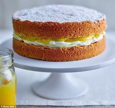 there is a cake on the plate with frosting and orange juice next to it