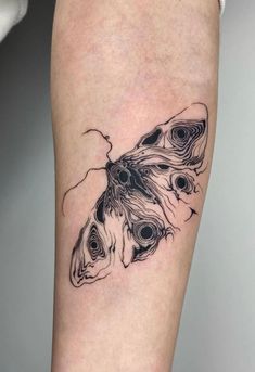 a black and white photo of a butterfly tattoo