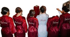 the bridesmaids are wearing red robes with their names written on them in white