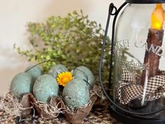 some eggs are sitting on a table next to a lantern