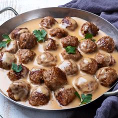 meatballs and gravy in a pan on a table