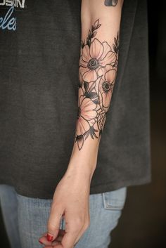 a person with a flower tattoo on their arm