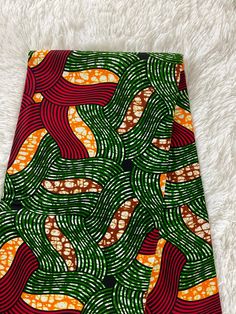 This green and red African Fabric is high quality African print made from 100% cotton and it's 45 inches wide. It is used for making African Clothing, African quilts, & For Home decoration. FYI: Print is Double sided. The listing is for 1, 6 yards and Headwrap Each piece of fabric measures:  36in by 45in for 1 yard 216in by 45in for 6 yards 72in by 22in for Head wrap If you purchase more than one yard, you will receive one continuous piece. *If you require more than what I have listed, feel free African Quilts, Clean And Press, Ankara Fabric, African Prints, Green And Red, African Fabric, Double Face, Head Wrap, African Clothing