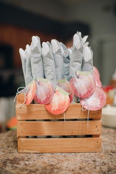 a wooden crate filled with candy and wrapped in plastic wrapper sitting on top of a counter