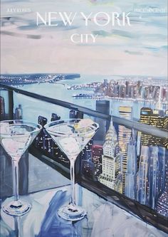 two martinis are sitting on a balcony overlooking the new york city skyline with skyscrapers in the background