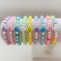 the bracelets are decorated with different colored beads and smiley faces on each bead