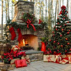 christmas trees and presents in front of an outdoor fireplace