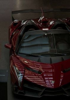 a red sports car parked in a garage