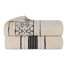 two white towels with black and white designs on the front, one is folded in half