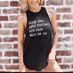 “Girls Who Love Football Are Rare. Wife ‘Em Up.” This High Neck, Flowing, Ribbed Tank Is So Cute! New Without Tags, Perfect Condition! Love The Item But Not The Price?! Make Me An Offer Open To Any And All Offers! Black Text Print Tank Top, Love Football, Ribbed Tank, Make Me An Offer, So Cute, High Neck, Womens Tops, Football, Tank Tops