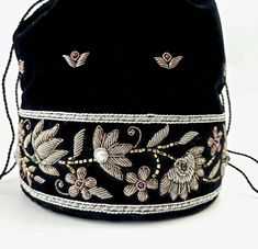 "Look your best wearing this luxurious black velvet pouch bag, exquisitely embroidered with glittery antiqued silver metallic threads and genuine semi precious stones. It is certain to bring you compliments. Perfect for an Indian wedding or for having fun around town! Expertly hand embroidered by third generation master zardozi artisans. Of heirloom quality. - 9\" x 6\" with useable interior space 6\" x 6 \". - Rigid bottom and 2\" base, so bag sits nicely. - Wrist cord with tassel, 6 in. drop p Bohemian Embroidered Potli Bag For Evening, Beaded Pouch Bag, Velvet Handbag, Embellished Purses, Beaded Pouch, Wrist Bag, Potli Bag, Embroidered Velvet, Potli Bags