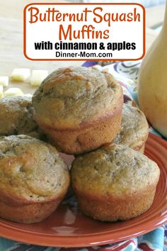 some muffins are stacked on top of each other with cinnamon and apples in the background