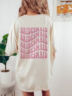 the back of a woman's shirt that says bridesmaid