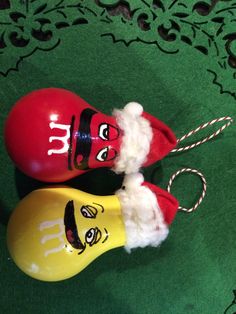 two red and yellow salt shakers sitting on top of a green tablecloth covered floor