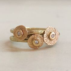 two gold rings with diamonds sitting on top of each other