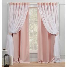 pink and white curtains hanging in front of a window